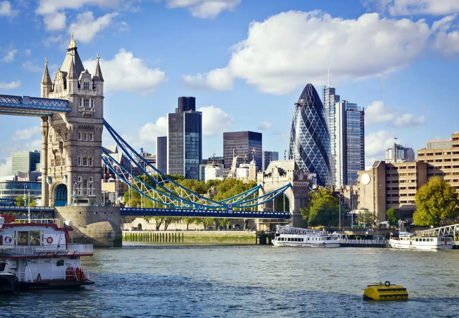 6 Cool Neighbourhoods in London You Ought to Visit London skyline featuring Tower Bridge, Tower of London, and The Gherkin.