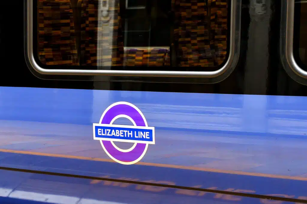 How to Get From Heathrow Airport to Central London Close up view of the side of a train on the new Elizabeth Line at London Paddington.